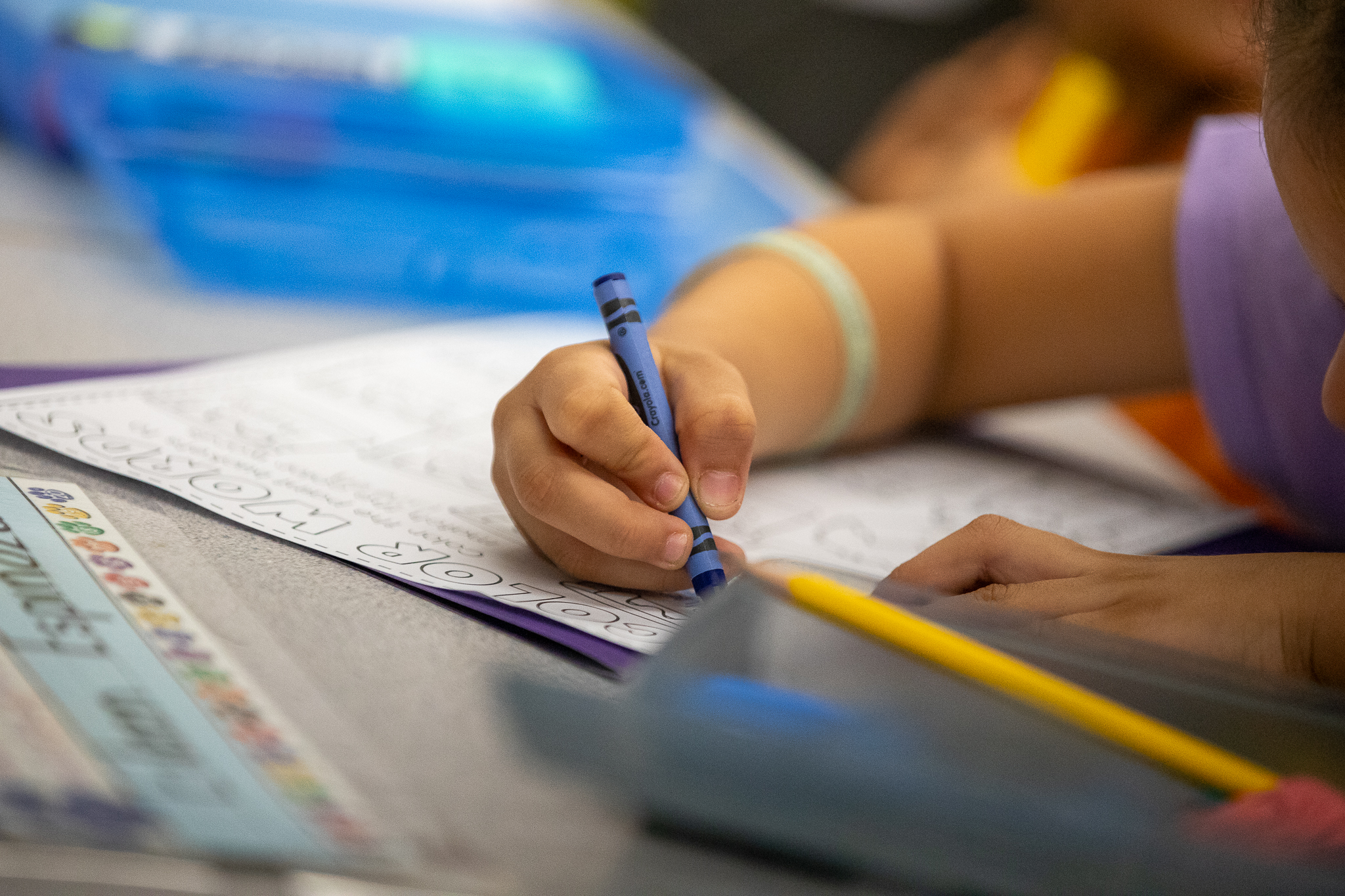 A student colors on a worksheet