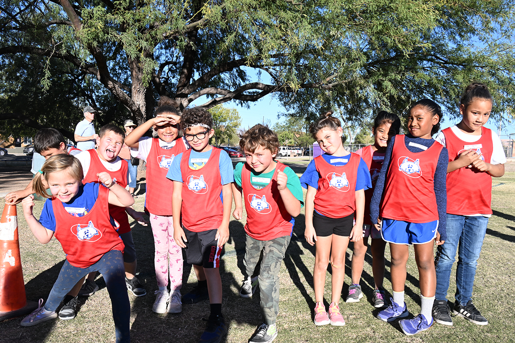 Cross country students smile for a photo in their uniforms